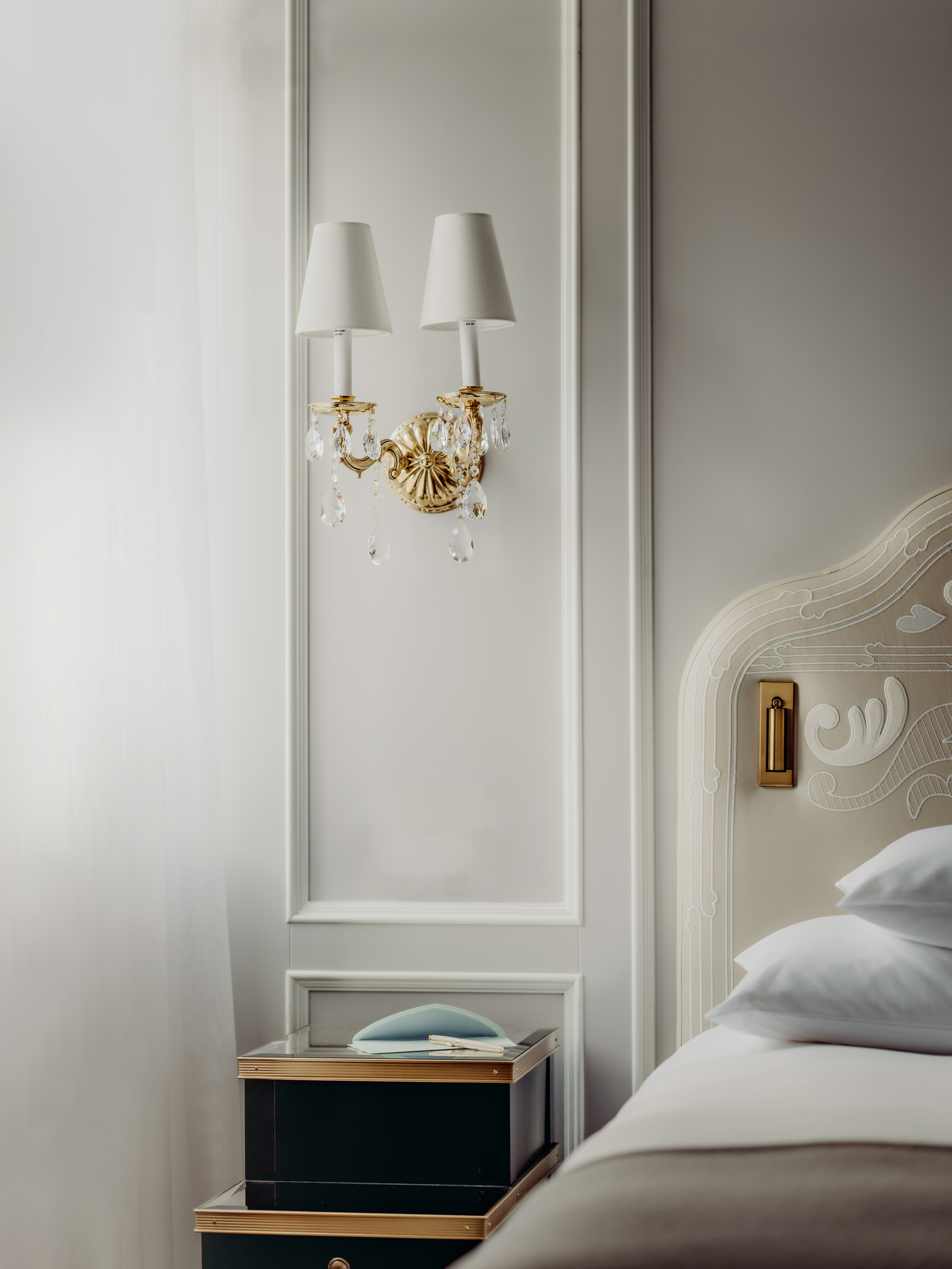 Badrutt's Palace - Elegant bedroom detail with a crystal wall sconce
